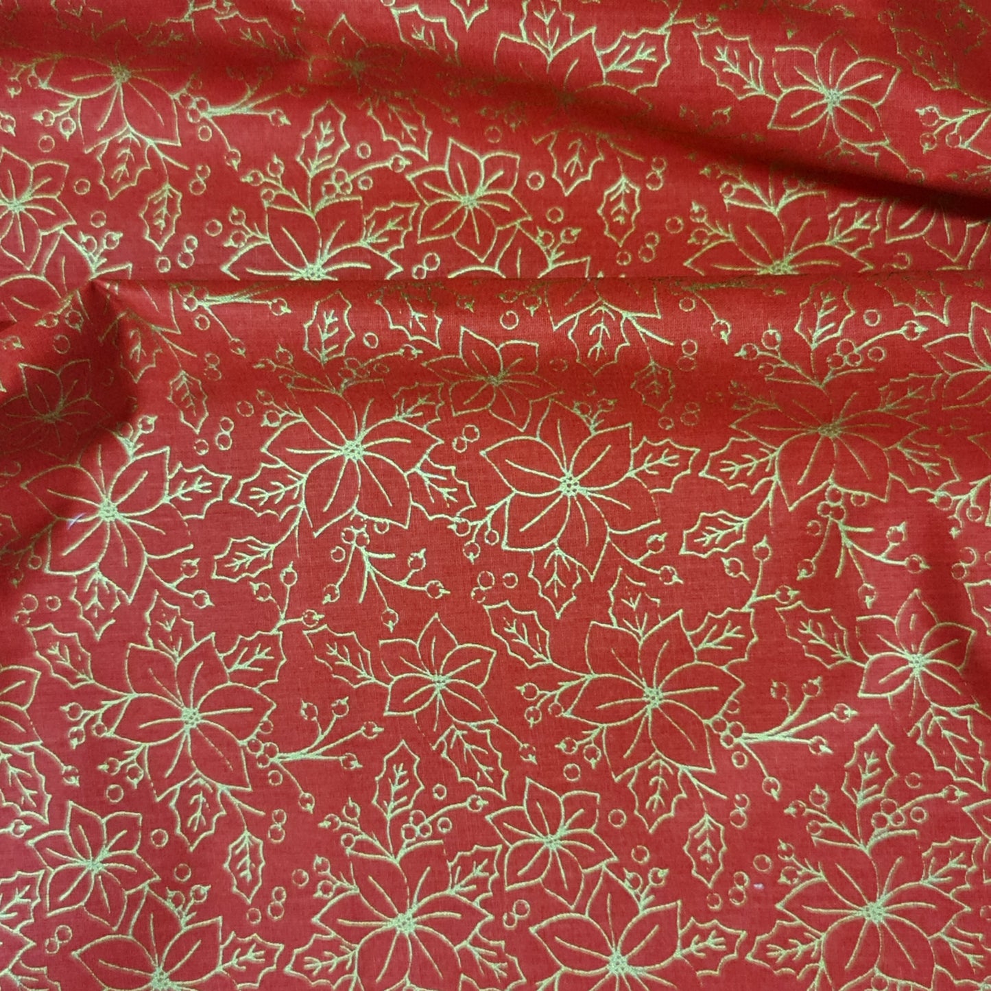 Tejido de flor navideña color dorado.