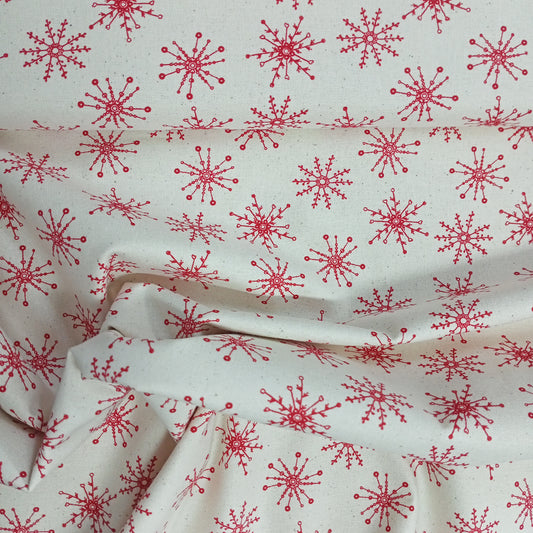 Tejido Copitos de navidad rojos sobre fondo beige