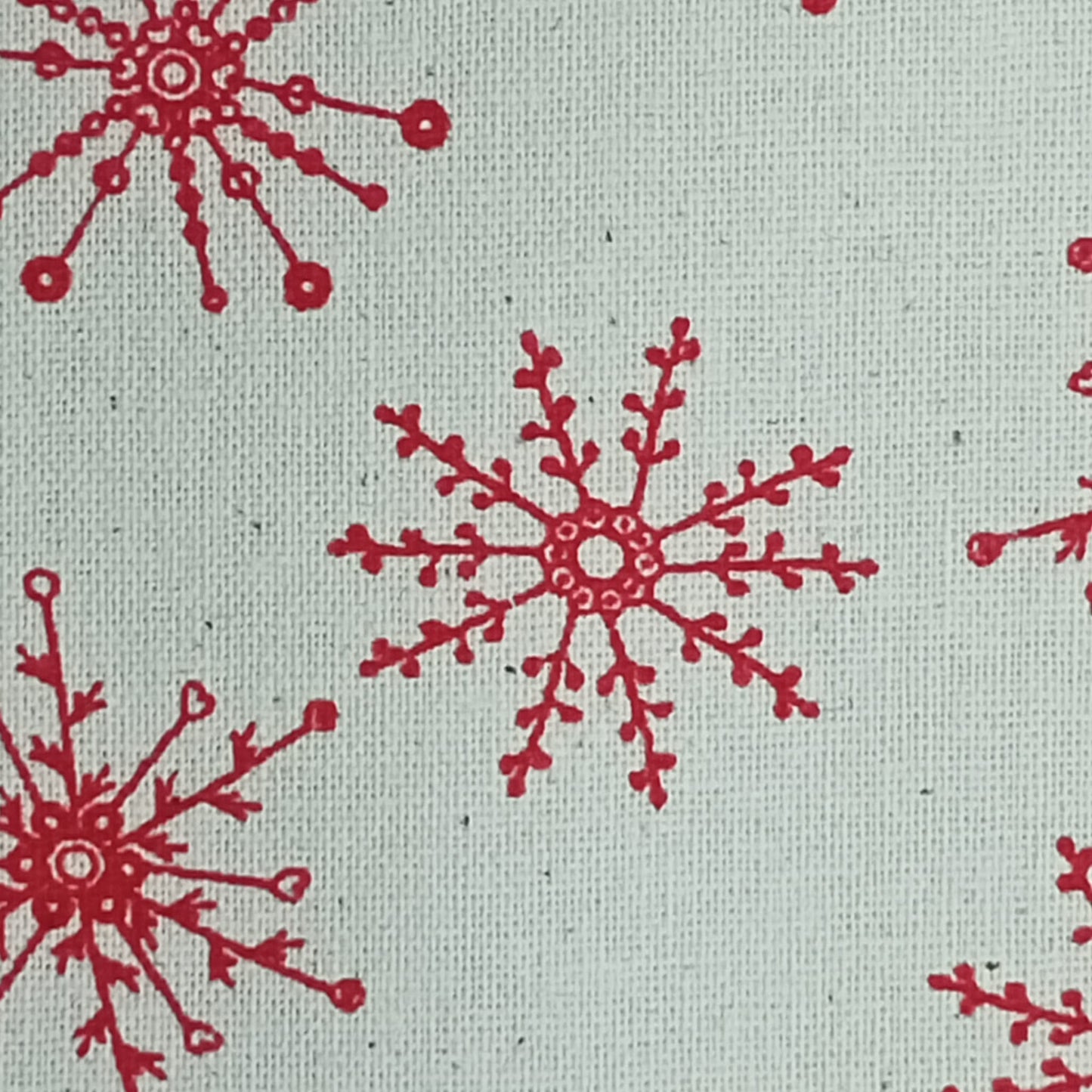 Tejido Copitos de navidad rojos sobre fondo beige